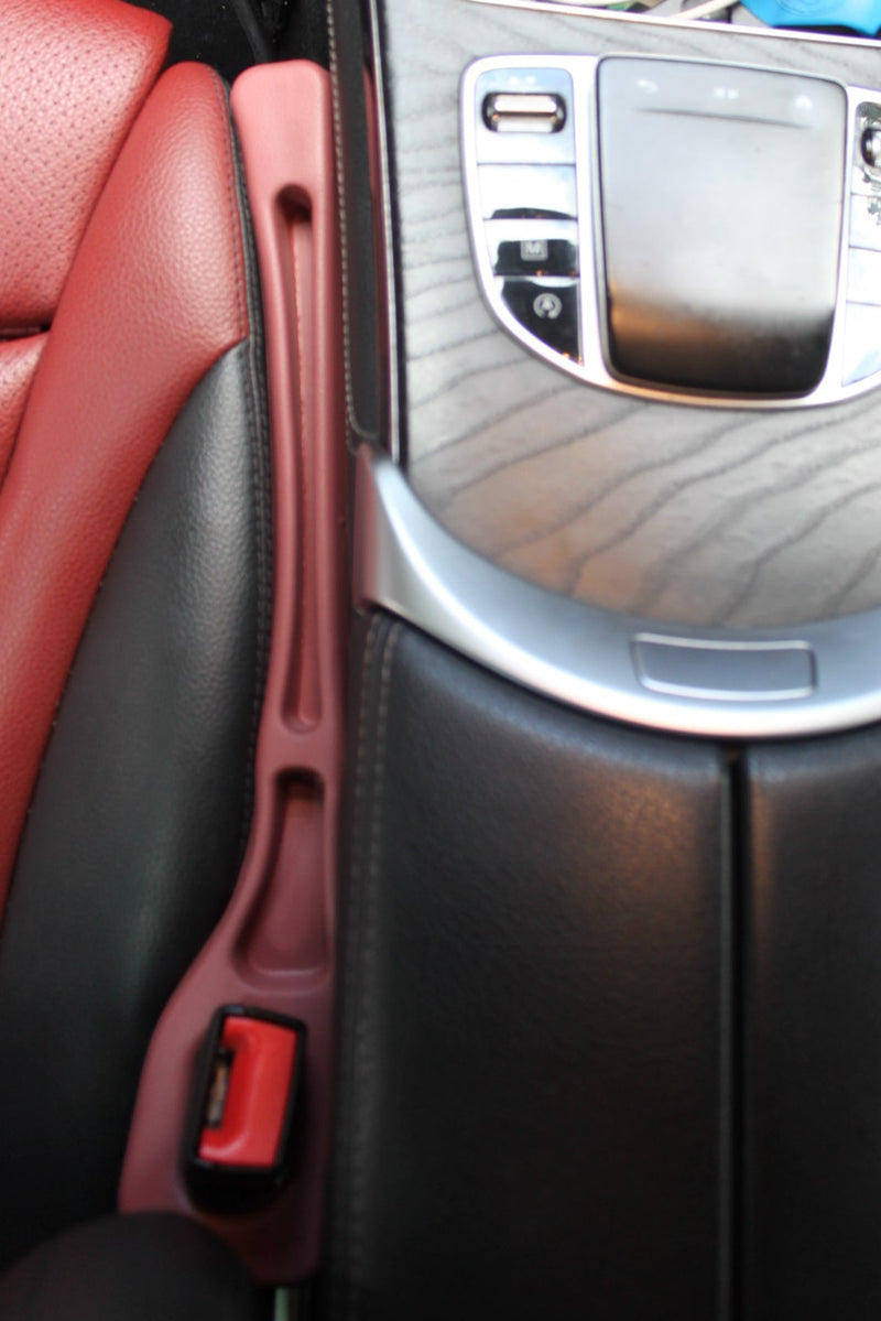 GapBuddy preventing a phone from dropping into the seat gap